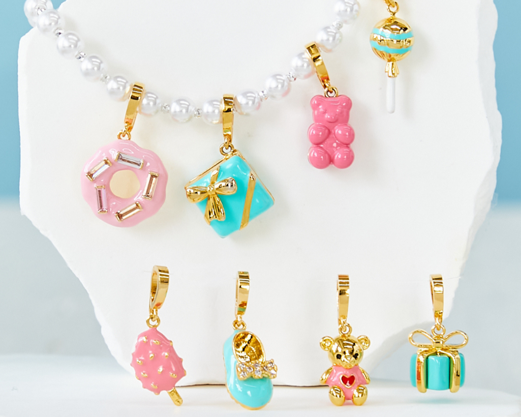 Collection of colorful charms on a white stand with a light blue background
